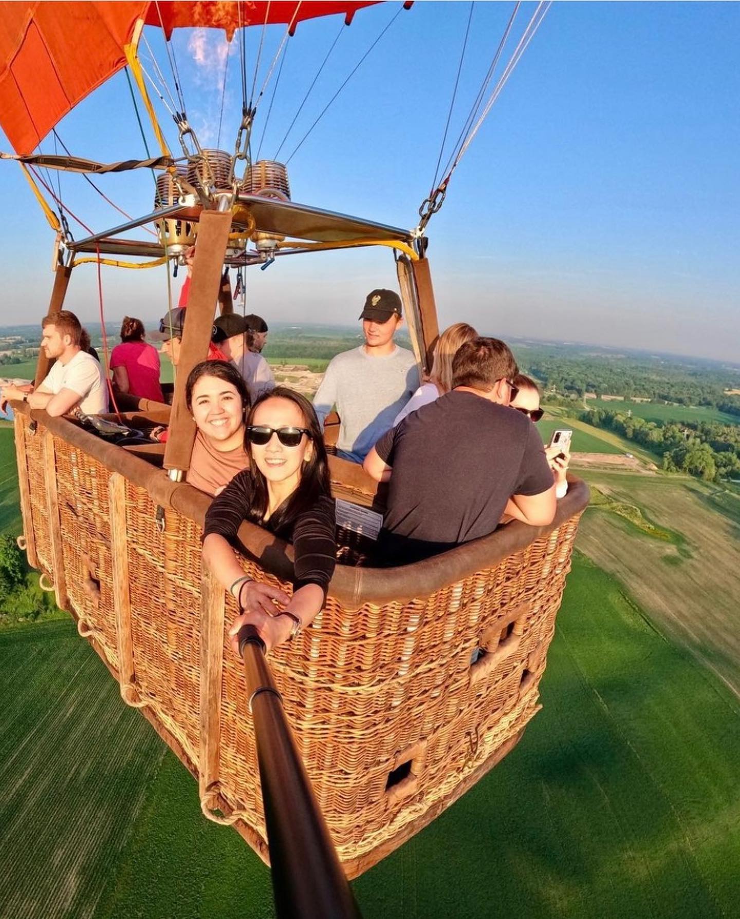 Hot air balloon flying over countryside near St. Jacobs